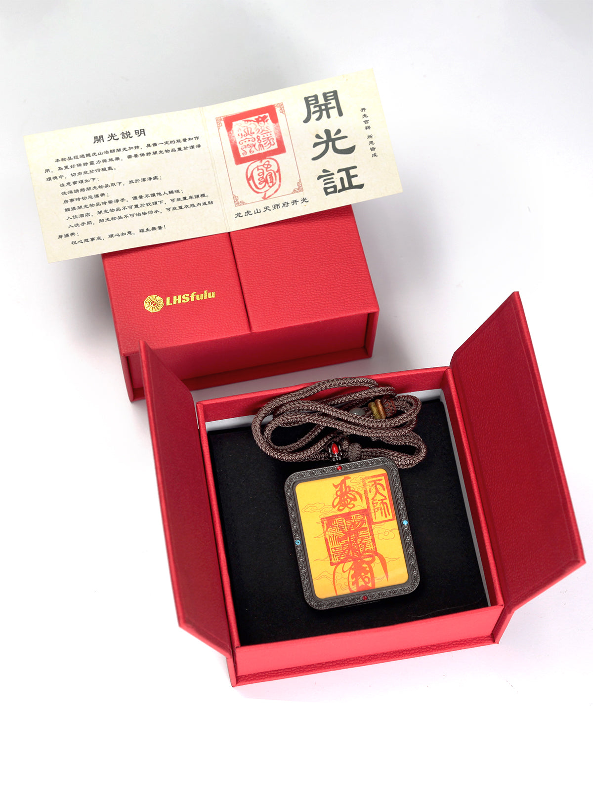 this talisman is personally hand-drawn by an orthodox Taoist master. An initiated High Priest then inscribes the talisman, channeling the sacred energy of the ancestral court, before sealing it within an exquisitely crafted Ghau box. This Peace &amp; Safety Talisman serves to protect your body and safeguard your well-being, warding off malevolent influences and neutralizing negative energy. It helps you steer clear of disasters, mitigates the impact of unforeseen accidents, and provides the wearer with comp