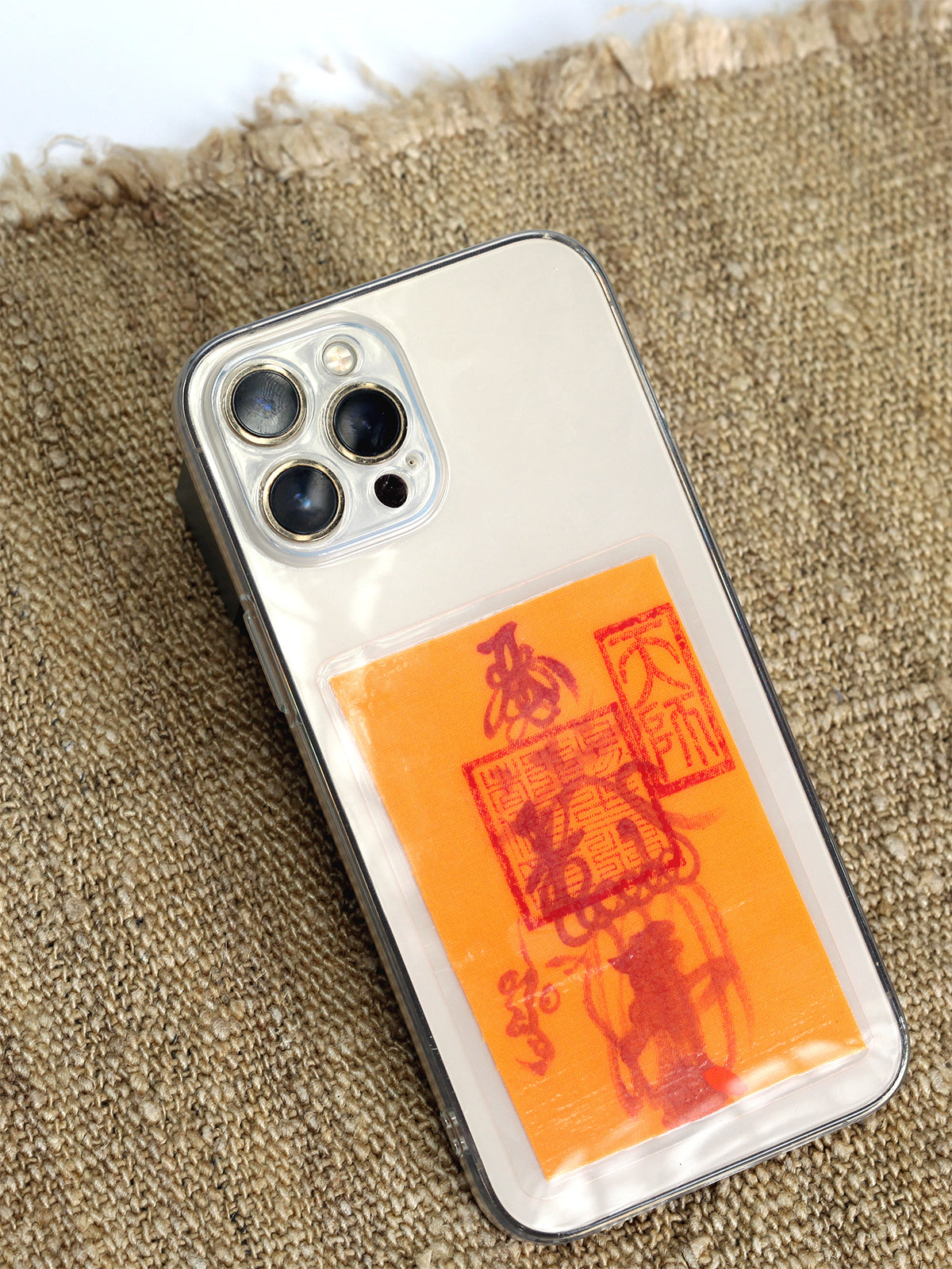 a mobile phone charm or sticker featuring a traditional Chinese Taoist talisman, hand-drawn by a Zhengyi lineage master from Longhu Mountain. 