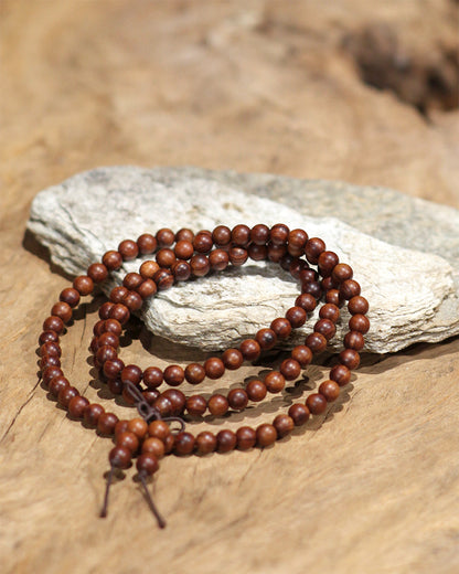 This long strand is composed of 108 thunderstruck wood beads, each one tempered by the power of natural lightning. It is created without any concrete symbols or writing, returning to the most authentic and primordial state of energy. To be wordless is to embody 'emptiness' (Śūnyatā), and thus, it can infinitely carry and resonate with your every state of mind and intention in the present moment.