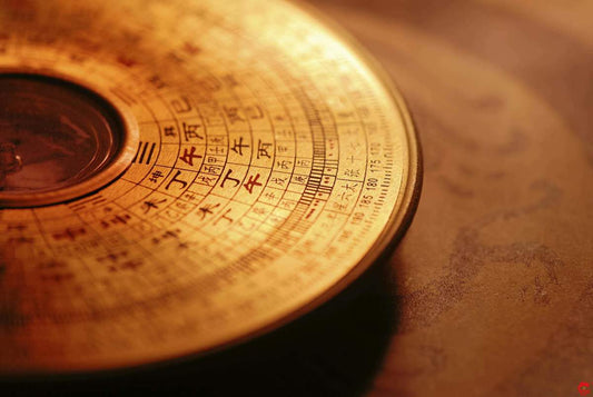 Close-up of an ancient Chinese astrolabe with intricate designs and text.